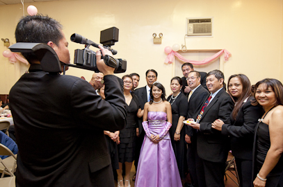Videographer filming a debut celebration by DJ Filipino